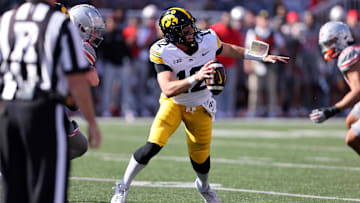 Oct 5, 2024; Columbus, Ohio, USA;  Iowa Hawkeyes quarterback Cade McNamara (12) drops back to throw against the Ohio State Buckeyes during the first quarter at Ohio Stadium. Mandatory Credit: Joseph Maiorana-Imagn Images