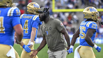 Nov 30, 2024; Pasadena, California, USA; UCLA Bruins head coach DeShaun Foster greets his players after a Bruins touchdown against the Fresno State Bulldogs in the third quarter at Rose Bowl. Mandatory Credit: Robert Hanashiro-Imagn Images