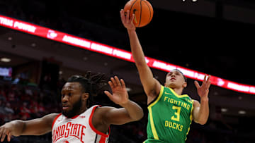 Jan 9, 2025; Columbus, Ohio, USA;  Oregon Ducks guard Jackson Shelstad (3) converts the layup over the defense of Ohio State Buckeyes guard Bruce Thornton (2) during the first half at Value City Arena. Mandatory Credit: Joseph Maiorana-Imagn Images