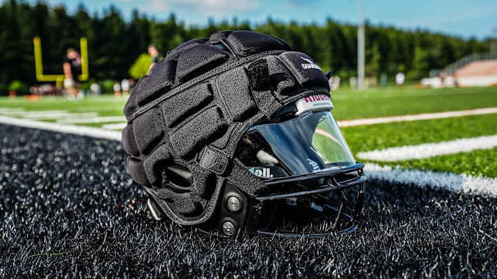 A Guardian cap helmet cover is shown during football practice at Grafton High School on Monday, August 12, 2024. The soft shell helmet cover is engineered to reduce injuries from impacts. A Guardian cap helmet cover is shown during football practice at Grafton High School on Monday, August 12, 2024. The soft shell helmet cover is engineered to reduce injuries from impacts.
