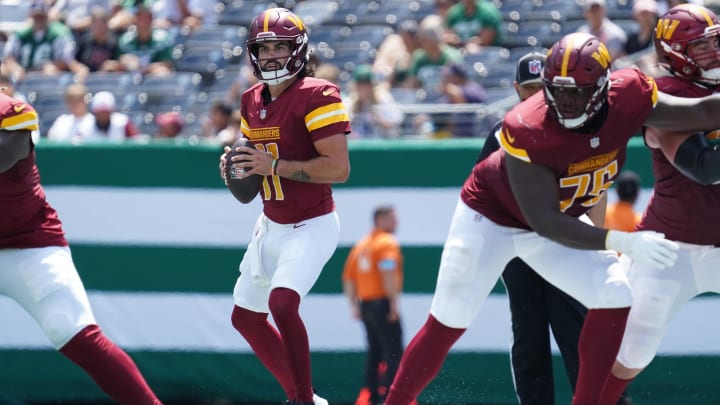 Aug 10, 2024; East Rutherford, New Jersey, USA; Washington Commanders quarterback Sam Hartman (11) surveys the field during the third quarter against the New York Jets at MetLife Stadium.