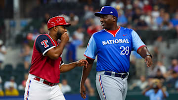 Jul 13, 2024; Arlington, TX, USA;  National League Future  coach Darren Oliver (r) laughs with American League Future coach Elvis Andrus during the game during the Major league All-Star Futures game at Globe Life Field.  Mandatory Credit: Kevin Jairaj-Imagn Images