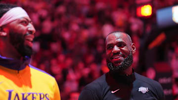 Dec 4, 2024; Miami, Florida, USA;  Los Angeles Lakers forward LeBron James, right, and forward Anthony Davis during pregame ceremonies before a game against the Miami Heat at Kaseya Center. Mandatory Credit: Jim Rassol-Imagn Images