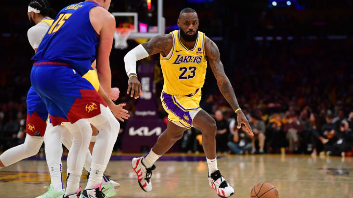 Apr 25, 2024; Los Angeles, California, USA; Los Angeles Lakers forward LeBron James (23) moves the ball against Denver Nuggets center Nikola Jokic (15) during the second half in game three of the first round for the 2024 NBA playoffs at Crypto.com Arena. Mandatory Credit: Gary A. Vasquez-USA TODAY Sports