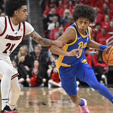Mar 1, 2025; Louisville, Kentucky, USA;  Pittsburgh Panthers guard Brandin Cummings (3) dribbles against Louisville Cardinals guard Chucky Hepburn (24) during the first half at KFC Yum! Center. Louisville defeated Pittsburgh 79-68. Mandatory Credit: Jamie Rhodes-Imagn Images