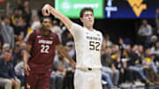 Dec 9, 2025; Morgantown, West Virginia, USA; West Virginia Mountaineers guard Treysen Eaglestaff (52) shoots a three pointer during the first half against the Little Rock Trojans at Hope Coliseum. Mandatory Credit: Ben Queen-Imagn Images