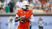 Miami Hurricanes quarterback Cam Ward (1) drops back to pass against the Georgia Tech Yellow Jackets in the third quarter at Bobby Dodd Stadium at Hyundai Field. 