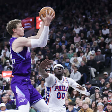 Dec 28, 2024; Salt Lake City, Utah, USA; Utah Jazz forward Lauri Markkanen (23) rebounds the ball against Philadelphia 76ers guard Reggie Jackson (00) during the third quarter at Delta Center. Mandatory Credit: Rob Gray-Imagn Images