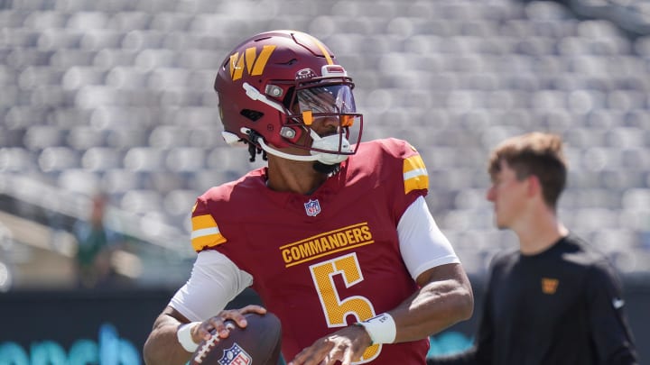 Aug 10, 2024; East Rutherford, New Jersey, USA; Washington Commanders quarterback Jayden Daniels (5) warms up before the game against the New York Jets at MetLife Stadium. Mandatory Credit: Lucas Boland-USA TODAY Sports