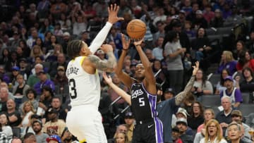 Mar 31, 2024; Sacramento, California, USA; Sacramento Kings guard De'Aaron Fox (5) shoots against Utah Jazz guard Keyonte George (3) during the second quarter at Golden 1 Center. Mandatory Credit: Darren Yamashita-USA TODAY Sports