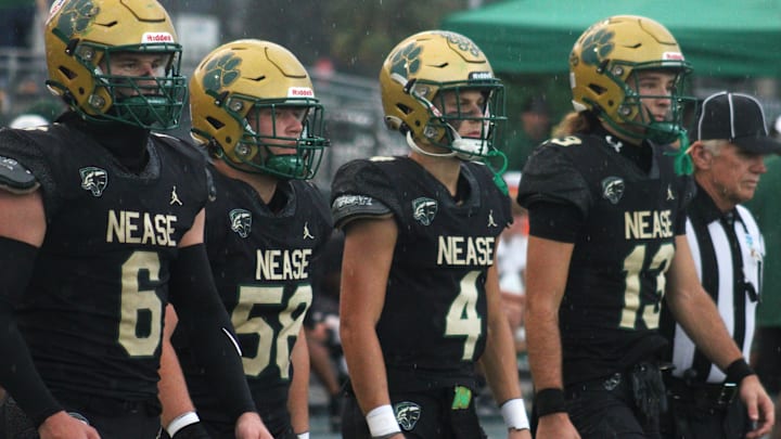 Nease captains Joe Miracle III (6), Brandon Strout (58), Nate Harry (4) and Tyler Ghazanfari (13) walk to midfield for the coin toss before a high school football game against Buchholz on September 30, 2024. [Clayton Freeman/Florida Times-Union]