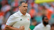 Sep 13, 2025; Miami Gardens, Florida, USA; Miami Hurricanes head coach Mario Cristobal runs on the field before the game against the South Florida Bulls  at Hard Rock Stadium. Mandatory Credit: Sam Navarro-Imagn Images