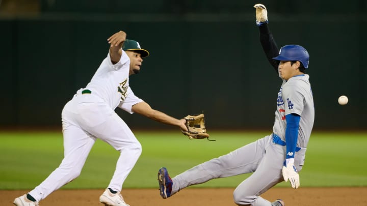 Aug 3, 2024; Oakland, California, USA; Los Angeles Dodgers designated hitter Shohei Ohtani (17) steals second base against Oakland Athletics infielder Darell Hernaiz (2) during the ninth inning at Oakland-Alameda County Coliseum.