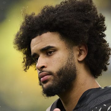 Oct 25, 2025; Eugene, Oregon, USA; Oregon Ducks quarterback Dante Moore (5) talks to officials during warm-ups before a game against the Wisconsin Badgers at Autzen Stadium. The Ducks are wearing uniforms celebrating the Grateful Dead. Mandatory Credit: Troy Wayrynen-Imagn Images