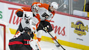 Oct 23, 2025; Ottawa, Ontario, CAN; Ottawa Senators center Tim Stutzle (18) moves in on Philadelphia Flyers goalie Dan Vladar (80) and defenseman Travis Sanheim (6) who controls the puck in the third period at the Canadian Tire Centre. Mandatory Credit: Marc DesRosiers-IMAGN Images