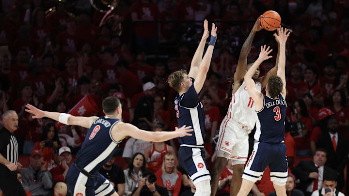 Feb 21, 2026; Houston, Texas, USA;  Houston Cougars forward Joseph Tugler (11) is defended by Arizona Wildcats guard Anthony Dell'orso (3) and center Motiejus Krivas (13) in the first half at Fertitta Center. Mandatory Credit: Thomas Shea-Imagn Images