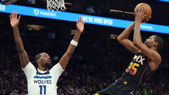 Apr 28, 2024; Phoenix, Arizona, USA; Phoenix Suns forward Kevin Durant (35) shoots over Minnesota Timberwolves center Naz Reid (11) during the second half of game four of the first round for the 2024 NBA playoffs at Footprint Center. Mandatory Credit: Joe Camporeale-USA TODAY Sports