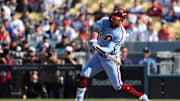 Oct 9, 2025; Los Angeles, California, USA; Philadelphia Phillies left fielder Kyle Schwarber (12) doubles in the first inning against the Los Angeles Dodgers during game four of the NLDS round for the 2025 MLB playoffs at Dodger Stadium. Mandatory Credit: Kiyoshi Mio-Imagn Images