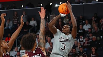 Feb 18, 2025; Starkville, Mississippi, USA; Mississippi State Bulldogs forward KeShawn Murphy (3) shoots against Texas A&M Aggies forward/center Pharrel Payne (21) and forward Andersson Garcia (11) during the second half at Humphrey Coliseum. Mandatory Credit: Petre Thomas-Imagn Images