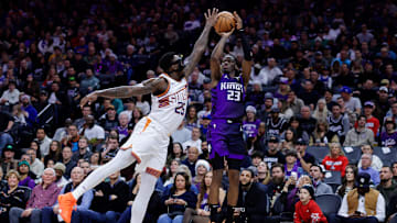 Dec 22, 2023; Sacramento, California, USA; Sacramento Kings guard Keon Ellis (23) shoots the ball against Phoenix Suns forward Nassir Little (25) during the fourth quarter at Golden 1 Center. Mandatory Credit: Sergio Estrada-Imagn Images