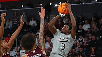 Feb 18, 2025; Starkville, Mississippi, USA; Mississippi State Bulldogs forward KeShawn Murphy (3) shoots against Texas A&M Aggies forward/center Pharrel Payne (21) and forward Andersson Garcia (11) during the second half at Humphrey Coliseum. Mandatory Credit: Petre Thomas-Imagn Images