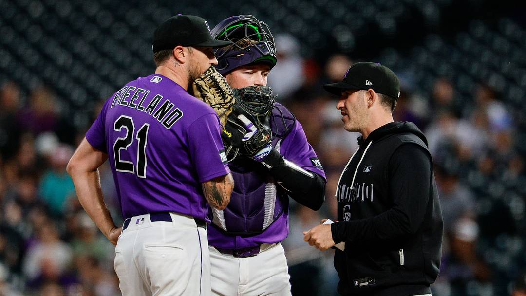 Colorado Rockies starting pitcher Kyle Freeland and catcher Hunter Goodman talk with pitching coach Alon Leichman  Credit: Isaiah J. Downing-Imagn Images