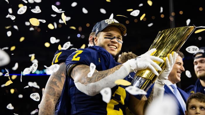 Jan 8, 2024; Houston, TX, USA; Michigan Wolverines running back Blake Corum (2) celebrates with the championship trophy after defeating the Washington Huskies during the 2024 College Football Playoff national championship game at NRG Stadium. 