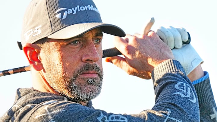 New York Jets quarterback Aaron Rodgers tees off on the first hole during the Phoenix Open Annexus Pro-Am at TPC Scottsdale on Feb. 5, 2025.