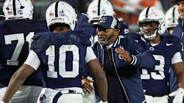 Nicholas Singleton #10 of the Penn State Nittany Lions celebrates with interim Head Coach Terry Smith after scoring a rushing touchdown against the Nebraska Cornhuskers during the first half at West Shore Home Field at Beaver Stadium on November 22, 2025 in State College, Pennsylvania.