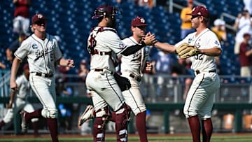 Jun 19, 2022; Omaha, NE, USA;  Texas A&M Aggies pitcher Brad Rudis (32) and catcher Troy Claunch (12) celebrate the win against the Texas Longhorns at Charles Schwab Field. Mandatory Credit: Steven Branscombe-Imagn Images