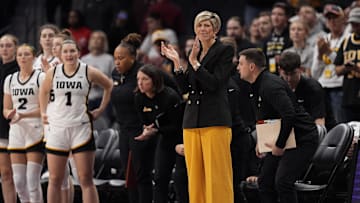 Nov 10, 2024; Charlotte, NC, USA; Iowa Hawkeyes head coach Jan Jensen applauds her teams win during the second half against the Virginia Tech Hokies at Spectrum Center. Mandatory Credit: Jim Dedmon-Imagn Images