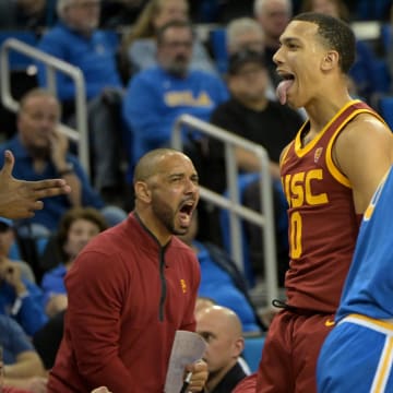 Feb 24, 2024; Los Angeles, California, USA;  USC Trojans guard Kobe Johnson (0) reacts after shooting a 3-point basket over UCLA Bruins guard Lazar Stefanovic (10) in the second half at Pauley Pavilion presented by Wescom. Mandatory Credit: Jayne Kamin-Oncea-USA TODAY Sports
