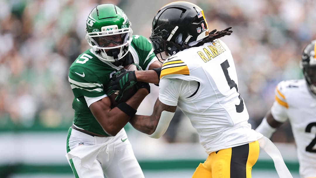 Sep 7, 2025; East Rutherford, New Jersey, USA; New York Jets wide receiver Garrett Wilson (5) runs the ball against Pittsburgh Steelers cornerback Jalen Ramsey (5) during the second half at MetLife Stadium. Mandatory Credit: Vincent Carchietta-Imagn Images