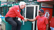 Angels manager Ron Washington (37, right) is greeted by former MLB manager Bobby Valentine before the game against the Houston Astros at Angel Stadium. Washington is stepping indefinitely away from the team due to health reasons on June 21.