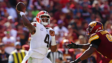 Oct 6, 2024; Landover, Maryland, USA; Cleveland Browns quarterback Deshaun Watson (4) throws a pass against Washington Commanders defensive end Dorance Armstrong (92) during the fourth quarter at NorthWest Stadium. Mandatory Credit: Peter Casey-Imagn Images