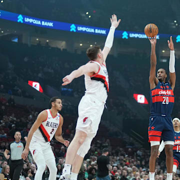 Mar 17, 2025; Portland, Oregon, USA; Washington Wizards power forward Alex Sarr (20) shoots over Portland Trail Blazers center Donovan Clingan (23) during the first half at Moda Center. Mandatory Credit: Soobum Im-Imagn Images