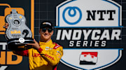 NTT IndyCar Series driver Alex Palou holds his second place trophy after the Music City Grand Prix at the Nashville Superspeedway in Lebanon, Tenn., Sunday, Aug. 31, 2025.