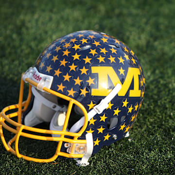 A vintage Crusaders' football helmet sits on the Michael A. Stofko Memorial Field at Archbishop Moeller High School