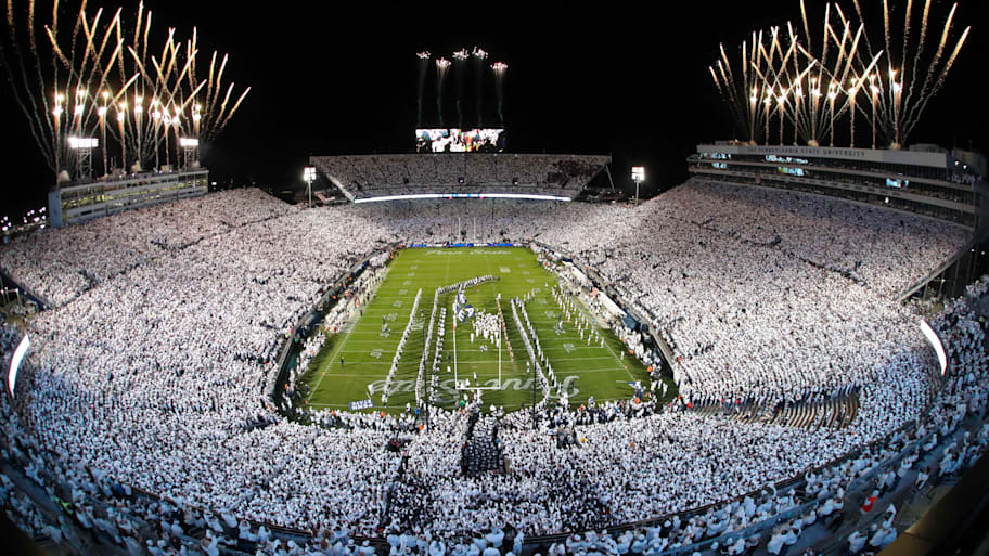 Fireworks burst overhead as the Penn State Nittany Lions take the field prior to a White Out game. 