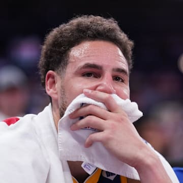 Golden State Warriors guard Klay Thompson (11) sits on the bench against the Sacramento Kings during a play-in game.