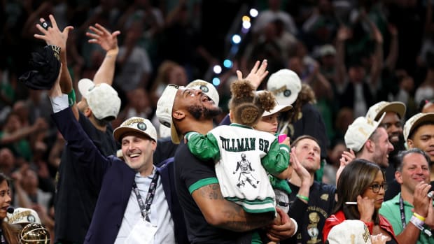 Jun 17, 2024; Boston, Massachusetts, USA; Boston Celtics forward Xavier Tillman (26) celebrates after winning the 2024 NBA Finals against the Dallas Mavericks at TD Garden. Mandatory Credit: Peter Casey-USA TODAY Sports