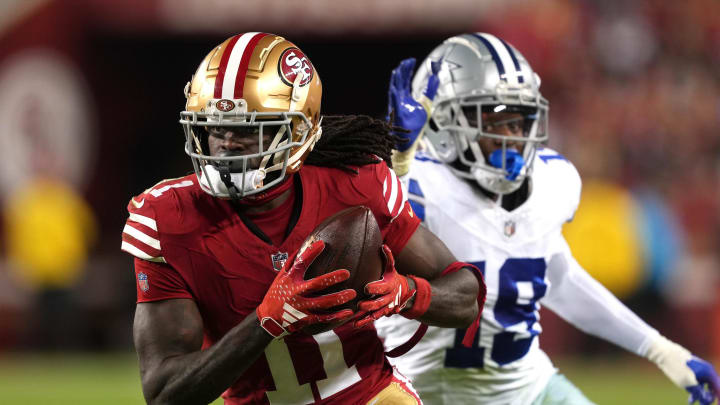 Oct 8, 2023; Santa Clara, California, USA; San Francisco 49ers wide receiver Brandon Aiyuk (11) runs after a catch against Dallas Cowboys cornerback Noah Igbinoghene (19) during the third quarter at Levi's Stadium. Mandatory Credit: Darren Yamashita-USA TODAY Sports