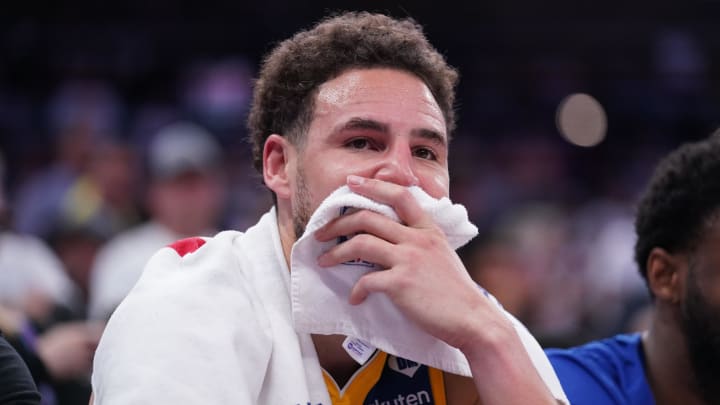 Apr 16, 2024; Sacramento, California, USA; Golden State Warriors guard Klay Thompson (11) sits on the bench during action against the Sacramento Kings in the fourth quarter during a play-in game of the 2024 NBA playoffs at the Golden 1 Center. 