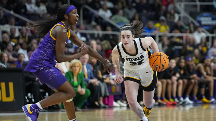 Apr 1, 2024; Albany, NY, USA; Iowa Hawkeyes guard Caitlin Clark (22) controls the ball against LSU Lady Tigers guard Flau'jae Johnson (4) in the fourth quarter in the finals of the Albany Regional in the 2024 NCAA Tournament at MVP Arena.