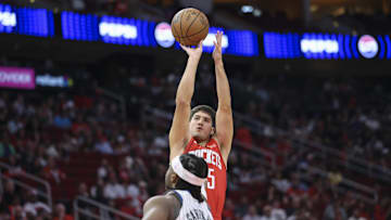 Nov 16, 2025; Houston, Texas, USA; Houston Rockets guard Reed Sheppard (15) shoots the ball over Orlando Magic center Wendell Carter Jr. (34) during the second quarter at Toyota Center. Mandatory Credit: Troy Taormina-Imagn Images
