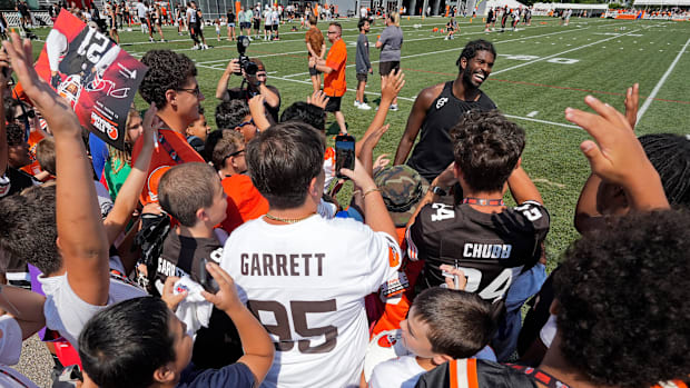 Cleveland Browns quarterback Shedeur Sanders (12) is all smiles as he meets fans after day eight of NFL training camp at Cros