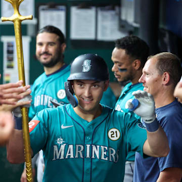 Sep 16, 2025; Kansas City, Missouri, USA; Seattle Mariners right fielder Dominic Canzone (8) is congratulated by teammates after hitting a home run in the second inning against the Kansas City Royals at Kauffman Stadium. Mandatory Credit: Scott Sewell-Imagn Images