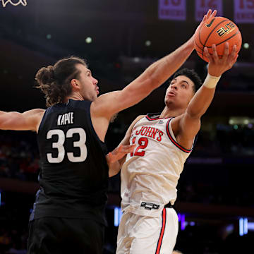 Mar 13, 2025; New York, NY, USA; St. John's Red Storm guard RJ Luis Jr. (12) drives to the basket against Butler Bulldogs forward Boden Kapke (33) during the second half at Madison Square Garden. Mandatory Credit: Brad Penner-Imagn Images