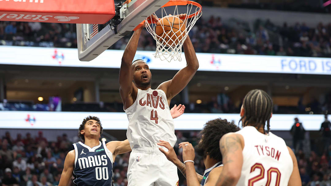 Mar 13, 2026; Dallas, Texas, USA;  Cleveland Cavaliers center Evan Mobley (4) dunks past Dallas Mavericks guard Max Christie (00) during the first half at American Airlines Center. Mandatory Credit: Kevin Jairaj-Imagn Images 