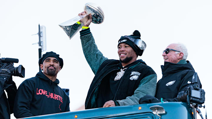 Philadelphia Eagles running back Saquon Barkley (26) lifts the Lombardi Trophy during the Super Bowl LIX championship parade